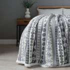 Christmas Fairisle Throw with Sherpa Back, Grey draped over bed