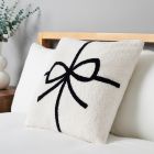 Christmas Present Bow Tufted Cushion, White on bed