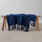 Juna Throw, Navy draped over coffee table