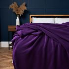 Microfleece Throw, Plum on bed agaisnt blue wooden panel wall