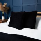 Small Microfleece Cushion, Black Styled on Bed