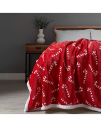 Christmas Candy Cane Throw with Sherpa Back, Red draped on foot of bed