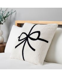 Christmas Present Bow Tufted Cushion, White on bed