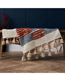 Global Blend Tufted Throw, Multicoloured draped over coffee table
