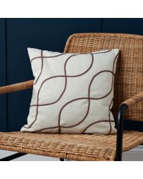 Soft Elegance Embroidered Cushion, Cream on chair against blue wooden panel wall